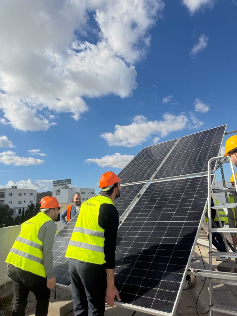 Formation photovoltaïque agréée ANME : stagiaires installant des panneaux solaires sur la plateforme BOOTCAMP